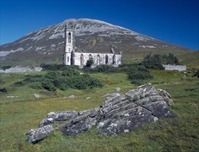 IRELAND, Donegal, Mount Errigal, Ruined church in The Poisened Glen with Errigal peak of the