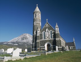 IRELAND, County Donegal, Dunlewy Village, Roman Catholic church and graveyard with Errigal peak of