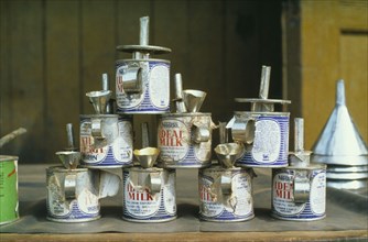 GHANA, Tarkwa, Nestle evaporated milk cans made into oil lamps.