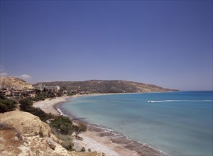 CYPRUS, Pissouri, Water skier and speed boat in Pissouri Bay encircled by quiet beach with