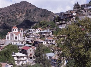 CYPRUS, Troodos Mountains, Moutoullas, Church and village houses on hillside.