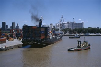 ARGENTINA, Buenos Aires, Tugboat and container ship in dock.
