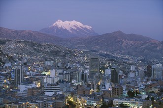 BOLIVIA, La Paz, Cityscape and Mount Illimani at dusk.