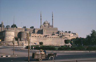 EGYPT, Cairo, The Citadel and Mohammed Ali Mosque. Man with a donkey and cart in the foreground.