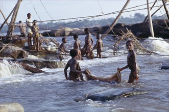 CONGO, Wagania, Children lifting fishing nets out of the water.