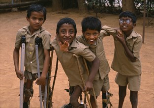 INDIA, Bangalore, Group of boys on crutches playing and laughing at The Institute for The Disabled.