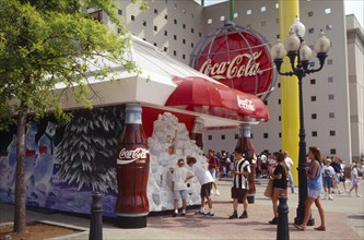 USA, Georgia, Atlanta, World of Coca Cola pavilion exterior with crowds of visitors.