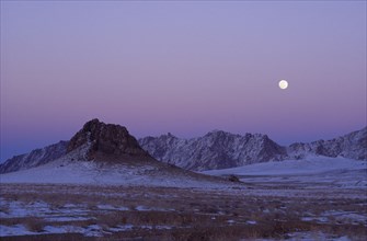 MONGOLIA, "				", Hovd Province, Mountains lightly covered in snow at sunset with pink sky. Rtnd 2