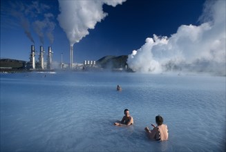 ICELAND, Svartsengi, The Blue lagoon Geothermal power plant with people bathing in the theraputic