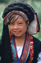 CHINA, Guizhou Province, Lijiang, Portrait of Bouyei girl in traditional costume.