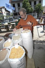 ROMANIA, Tulcea, Tulcea, Buyer checking sacks of lentils pulses rice and wheat at the fresh produce
