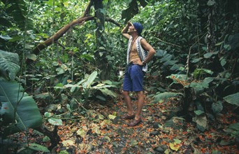 COSTA RICA, Limon Province, Ecotourism, Caribbean ecotourist birdwatching in rainforest near