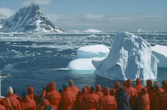 ANTARCTICA, Antarctic Peninsula, Tourists, Tourist group looking at iceberg from cruise ship near