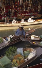 THAILAND, South, Bangkok, Damnoen Saduak Floating Market with an old female fruit vendor in her