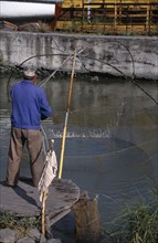BULGARIA, Burgas, Fisherman with traditional hand held net