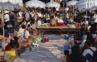 CAMBODIA, Siem Reap, Angkor Wat, Shaman ceremony watched by Khmer people and tourists with food