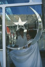 PAKISTAN, Northern Areas, Gilgit, Barbers shop with star and moon of the Pakistan flag inlaid on