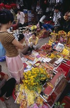 CAMBODIA, Siem Reap, Display of various religious goods for sale in the old market during Chinese
