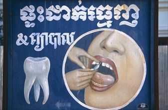 CAMBODIA, Siem Reap, Dentists sign depicting an injection into a persons gums next to a single