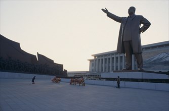 NORTH KOREA, Pyongyang, "Woman bowing in respect in front of statue of Kim II Sung, the Grand