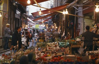 ITALY, Sicily, Palermo, Vucciria Market.  Narrow street lined with fruit and vegetable stalls.