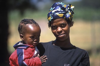 SOUTH AFRICA, Western Cape, Paarl, Farm labourers wife and child at Fairview goats cheese and wine