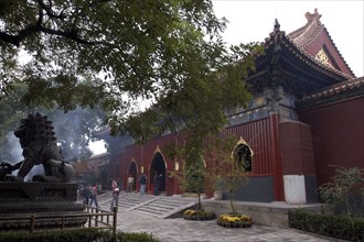 CHINA, Beijing, Lama Temple. People looking around the buildings of the Temple complex with stone