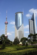 CHINA, Shanghai, Modern city architecture seen from formal gardens