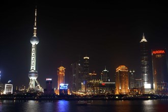 CHINA, Shanghai, Waterfront city skyline and TV tower illuminated at night