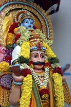 SINGAPORE, , Colourful statue decorated with flower garlands at an Indian Hindu Temple