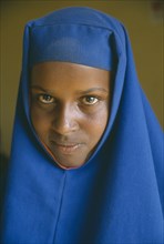 ETHIOPIA, Jijiga, Portrait of Somali girl in blue head dress.  The Somali are one of the key ethnic