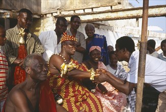GHANA, Accra, Ashanti chief receiving obeisance in village outside Accra.