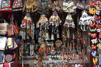 CHINA, Beijing, Market stall displaying selection of bells bags and chimes with assortment of