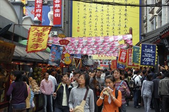 CHINA, Beijing, Busy shopping street with overhead flag signs