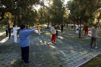 CHINA, Beijing, Group of people doing Tai Chi in the park