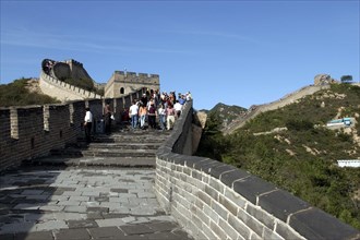 CHINA, Great Wall, View along a section of the wall with tourists walking down steps