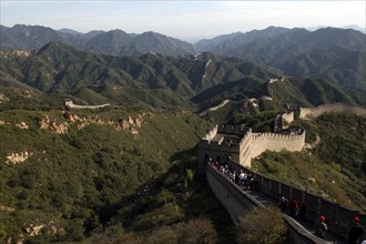 CHINA, Great Wall, View over a section of the wall which leads through the green hilly landscape