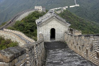 CHINA, Great Wall, View along a section of the wall toward small rooved and walled building