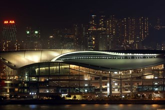 HONG KONG, Kowloon, View of the New Convention Centre illuminated at night