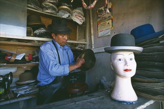 BOLIVIA, La Paz, El Alto, La Ceja.  Hatmaker making traditional bowler style hats.