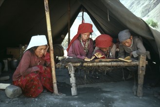 AFGHANISTAN, Tribal People, Kirghiz children taking lessons inside yurt.