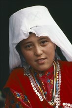AFGHANISTAN, Tribal People, Head and shoulders portrait of Kirghiz girl.