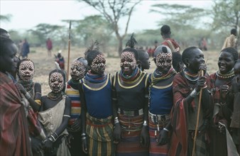UGANDA, Karamoja  , Young Karamojong girls with giraffe markings painted on their faces in