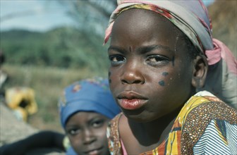 NIGERIA, Jos, Portrait of young girl with facial tattoos.