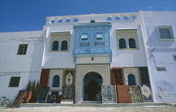 TUNISIA, Kairouan, Rug shop facade with display of rugs outside