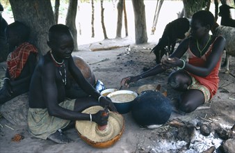 SUDAN, Tribal People, Dinka woman making mung bean and groundnut paste.