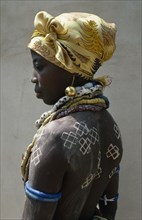 GHANA, Initiation Ceremony, Portrait of a Dipo girl dressed in venetian beads and gold earrings for