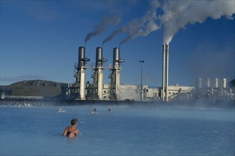 ICELAND, Gullbringu, Reykjanes, Svartsengi geothermal power plant with bathers in Blue Lagoon in