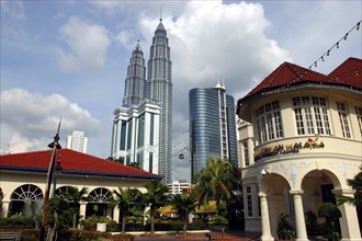 MALAYSIA, Kuala Lumpur, View from city street toward the Petronas Towers and other tall