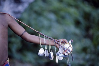 PAPUA NEW GUINEA, Trobriand Islands, Cropped shot of extended arm displaying kula necklace.